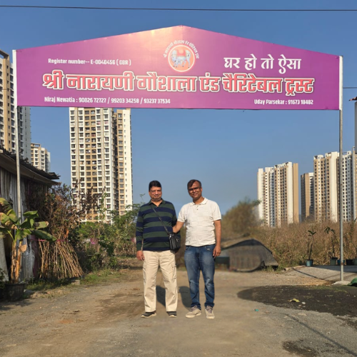 Entrance gate of Shree Narayani Gosala with team members standing together at the main entrance