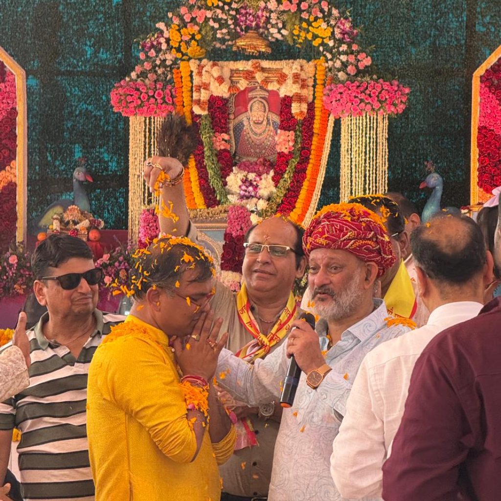 Devotees receiving blessings during Shree Narayani Gosala inauguration ceremony with flower shower and spiritual rituals